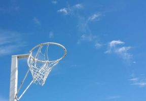 white basketball hoop against blue sky