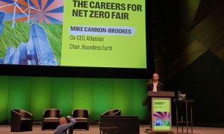 Image of Mike Cannon-Brookes on stage presenting at the careers for net zero fair