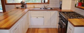 Create a warm and inviting kitchen with new timber benchtops.