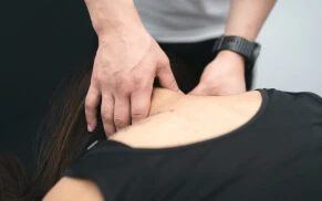 Therapist providing head massage for headache relief.